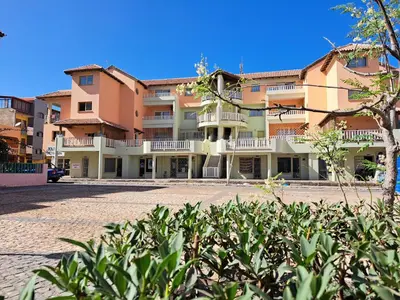 a large apartment building with a hedge in front of it at Sal service coquero in Santa Maria