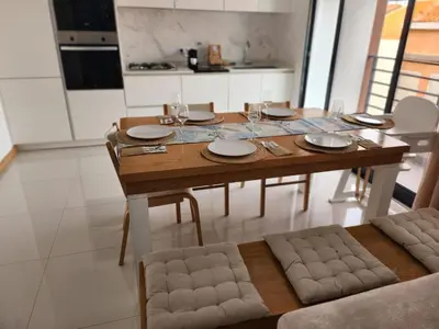 a wooden table with plates and glasses on it in a kitchen at Boa Mindelo Beach in Mindelo