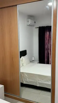 a bedroom with a mirror with a bed in it at Apartamento moderno I - T1 - Cidade do Porto Novo - Ilha Santo Antão in Porto Novo