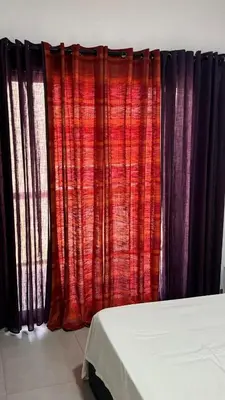 a red and black curtain in a room at Apartamento moderno I - T1 - Cidade do Porto Novo - Ilha Santo Antão in Porto Novo