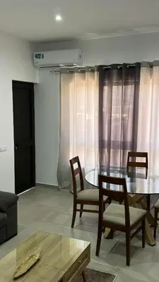 a living room with a dining room table and chairs at Apartamento moderno I - T1 - Cidade do Porto Novo - Ilha Santo Antão in Porto Novo