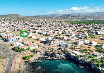 an aerial view of a city with buildings and water at Kaza Papaya - Papaya House in Tarrafal