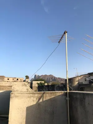 a street light on a wall with a mountain in the background at Simple sunlight apartment - Assomada in Assomada