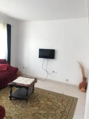 a living room with a tv on a white wall at Simple sunlight apartment - Assomada in Assomada