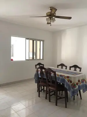 a dining room with a table with chairs and a ceiling fan at Simple sunlight apartment - Assomada in Assomada