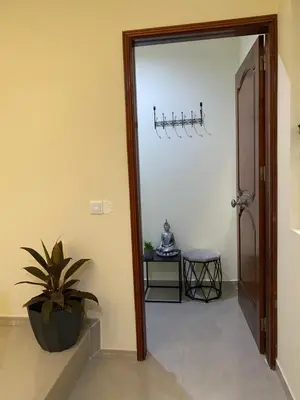 a hallway with a door leading into a room with a plant at T1 Férias Mindelo in Mindelo