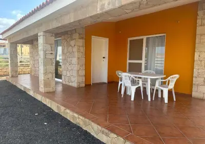 a patio with a table and chairs on a house at Villa Baleia Stella Maris Exclusive in Calheta Do Maio
