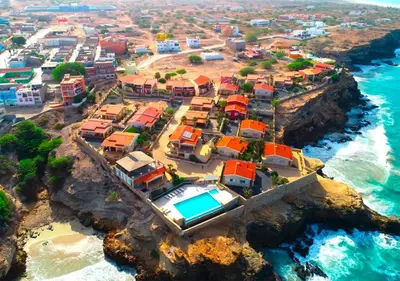 a group of houses on a cliff near the ocean at Villa Baleia Stella Maris Exclusive in Calheta Do Maio