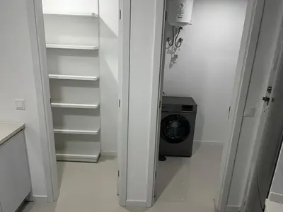 a white kitchen with a refrigerator and a washing machine at ROYAL PALMAREJO APPARTAMENTO in Praia