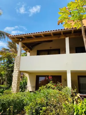 a white house with a palm tree in front of it at Apartment Terrace - front sea view From - May till September in Santa Maria