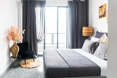 a bedroom with a bed and a chair and a window at Morabezahome - Zaza in Mindelo