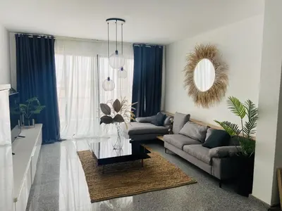 a living room with a couch and a table at Morabezahome - Zaza in Mindelo