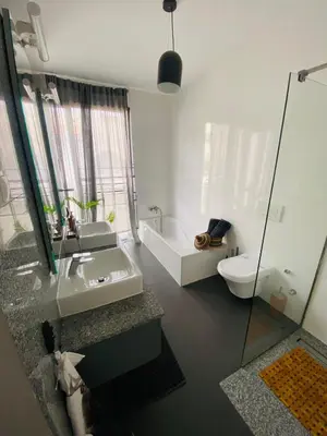a bathroom with a sink and a tub and a toilet at Morabezahome - Zaza in Mindelo