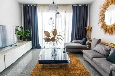 a living room with a couch and a glass coffee table at Morabezahome - Zaza in Mindelo
