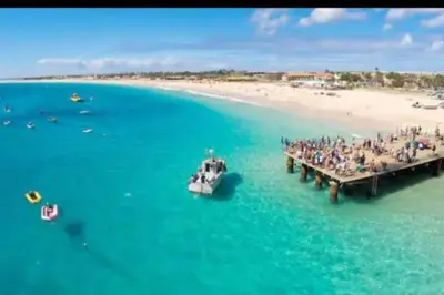 a boat in the water next to a pier at NEW Luxury Condo - In the heart of Santa Maria in Santa Maria