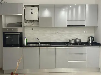 a kitchen with stainless steel cabinets and a sink at Casa Mendes- Quarto Casal in Praia