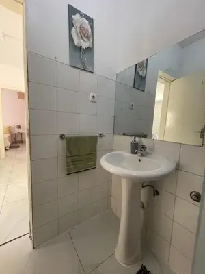 a white bathroom with a sink and a mirror at house of happiness in Praia