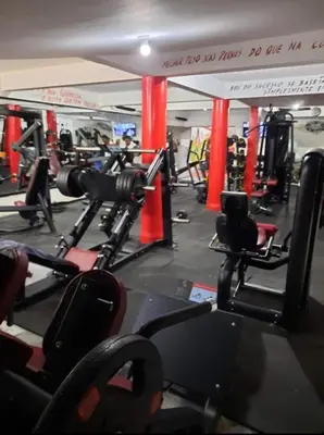 a gym with lots of machines and a sign at My Flat 0 in Praia