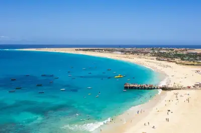 an aerial view of a beach with people and boats at Salty Apartments in Santa Maria