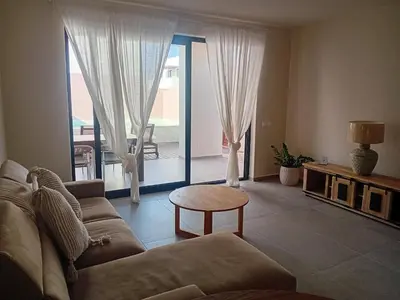 a living room with a couch and a table at Vila Cristina Alojamento, Praia Estoril, Boa Vista in Sal Rei