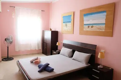 a bedroom with a bed with blue towels on it at Nagoia's place com varanda, piscina e super wi-fi in Santa Maria