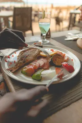 a plate of food on a table with a glass of water at Agua Hotels Sal Vila Verde in Santa Maria