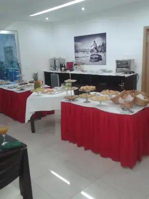 two tables with food on them in a room at Apartamentos Santiago - Praia in Praia