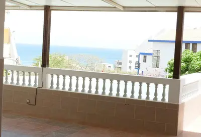 a white balcony with a view of the ocean at wonder of the archipelago in Praia