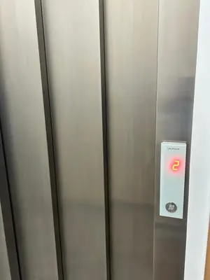an elevator door with an exit sign on it at Apartamento Ilhas in Praia