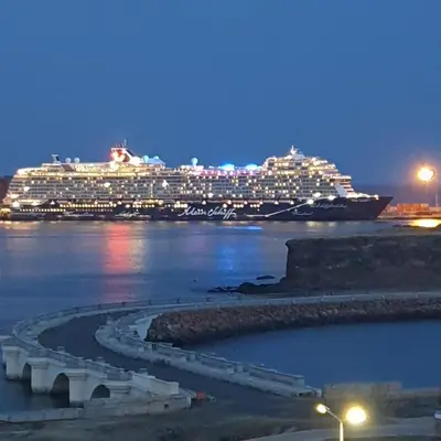 a cruise ship in the water at night at Gamboa Praia in Praia