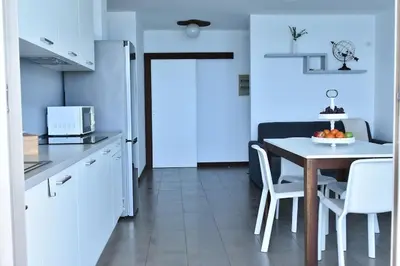 a kitchen with a table and chairs in a kitchen at Duarte Apartments - Las Rochas in Mindelo