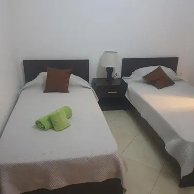 two beds sitting next to each other in a room at Gamboa-1 Praia in Praia