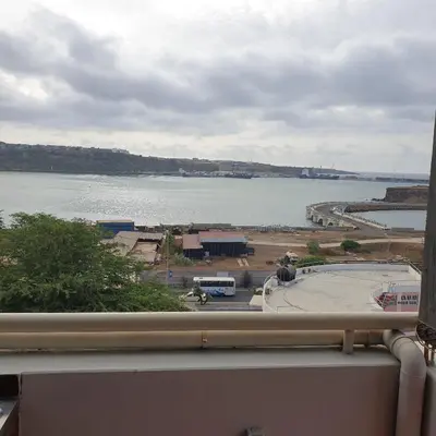 a view of a large body of water from a balcony at Gamboa-1 Praia in Praia