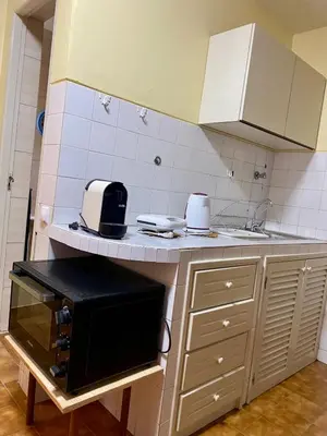 a kitchen with a counter with a microwave on it at Huizenmarkt Caboverde in Mindelo