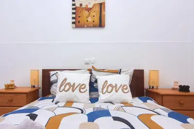 a bedroom with a bed with love pillows on it at Casa Irma in Santa Maria