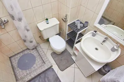 a bathroom with a white toilet and a sink at Casa Irma in Santa Maria