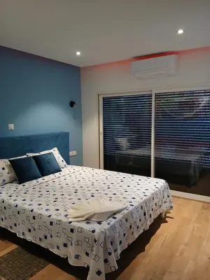 a bedroom with a large bed and a window at Casa Cantinho d`ouro in Ponta do Sol