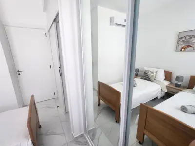 a room with a mirror and a bed and a couch at Boa Mindelo City in Mindelo