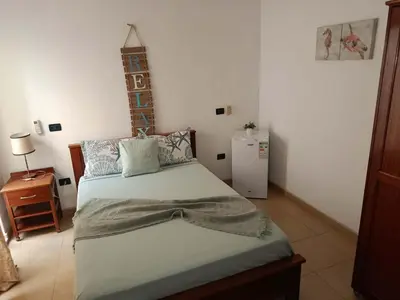 a bedroom with a bed in a room at City Center Near Beach B&B in Tarrafal