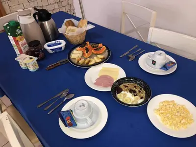a blue table with plates of food on it at City Center Near Beach B&B in Tarrafal