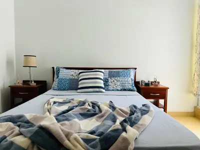 a bedroom with a bed with a blanket on it at City Center Near Beach B&B in Tarrafal