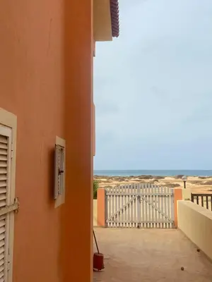 a view of the beach from the balcony of a house at Coral beach house in Santa Maria