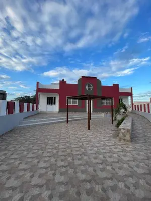 a red and white building with a roof at Katila-Rooms-Lima in Espargos