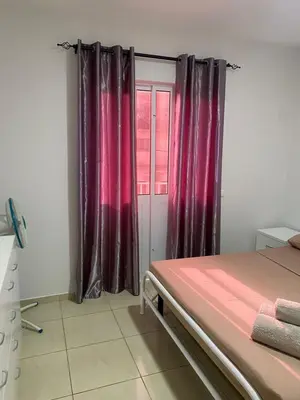 a bedroom with red curtains and a window at Katila-Rooms-Lima in Espargos