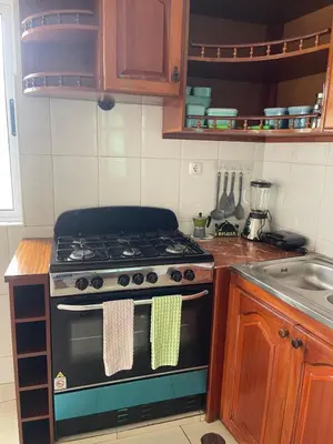 a kitchen with a stove top oven in a kitchen at Katila-Rooms-Lima in Espargos