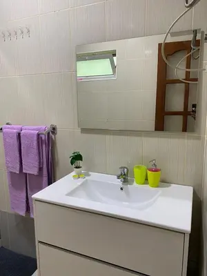 a bathroom with a white sink and a mirror at Katila-Rooms-Lima in Espargos