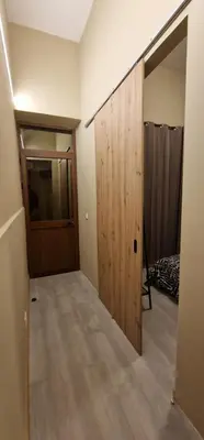 a room with a wooden door and a bedroom at City Center Mindelo 37 in Mindelo