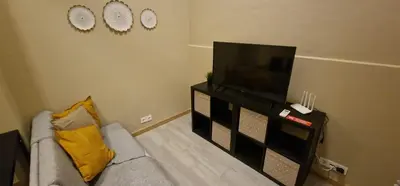 a living room with a couch and a flat screen tv at City Center Mindelo 37 in Mindelo