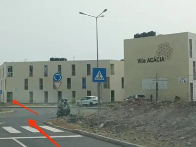 a building with a sign on the side of a road at Casa do Encanto in Praia