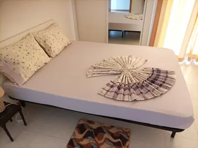 a bed with a pillow and a hat on it at Casa do Encanto in Praia